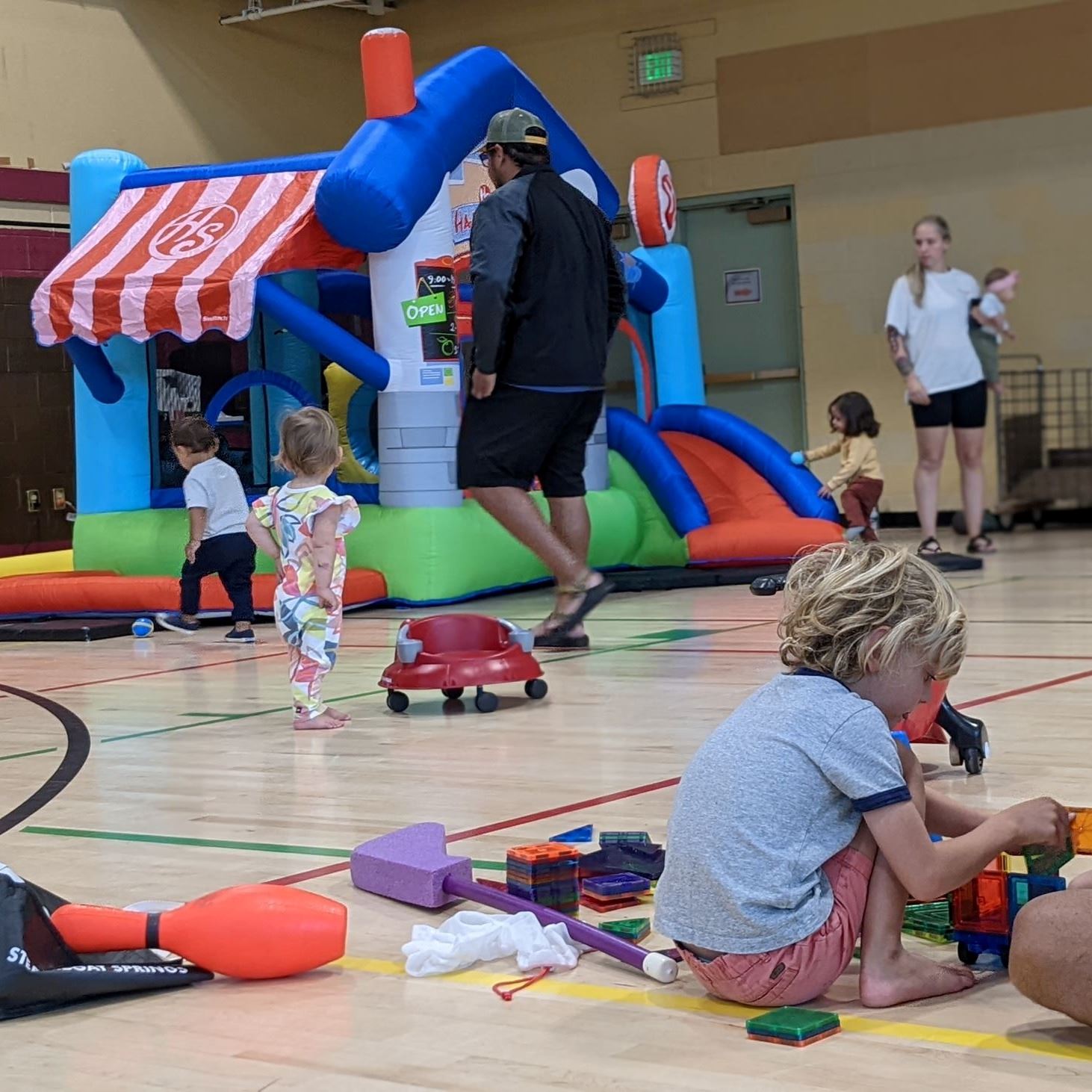 Young children exploring bounce-house and floor-play activities at Little Rec.