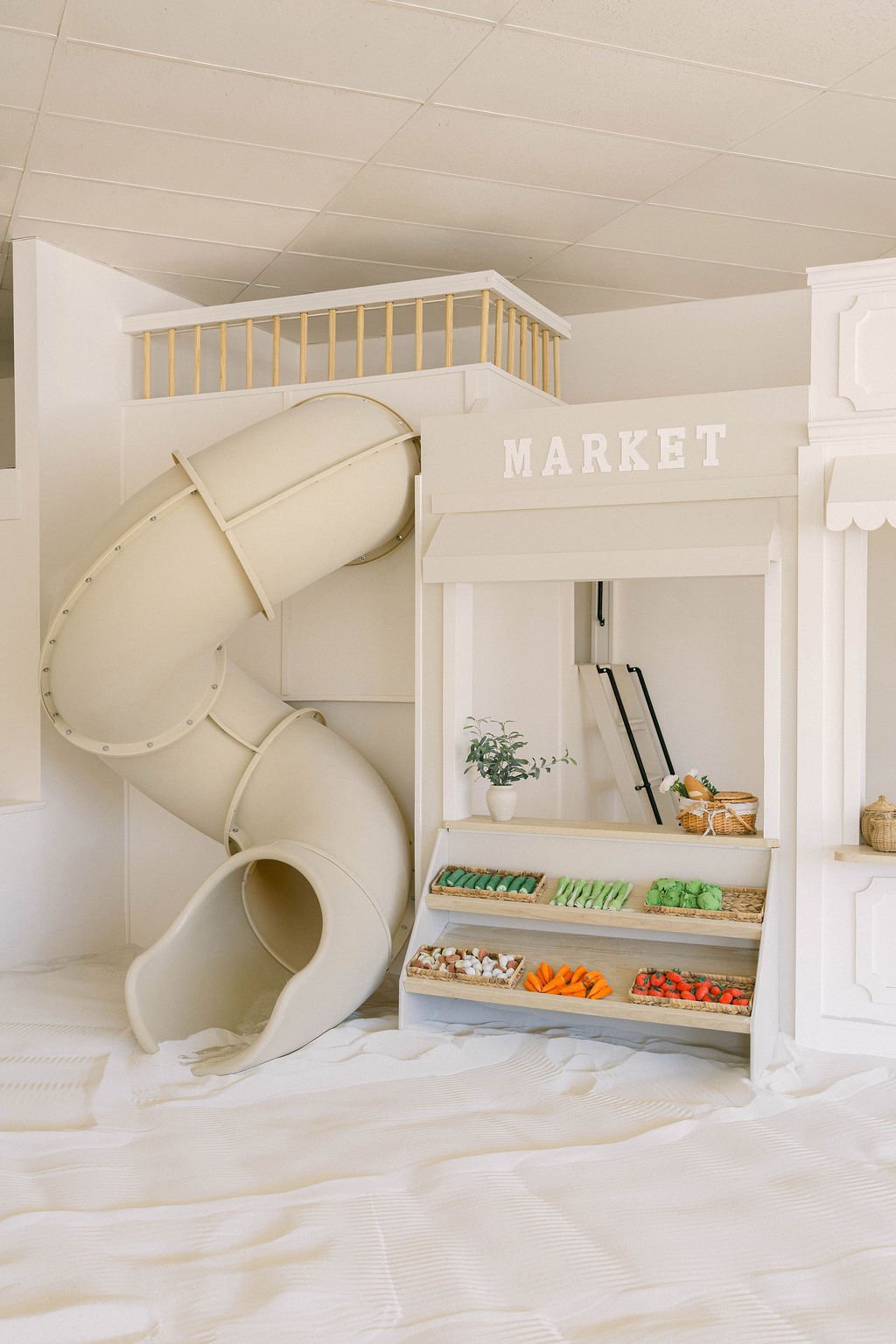 Play market and tube slide inside The Little Sandbox in Wayne.