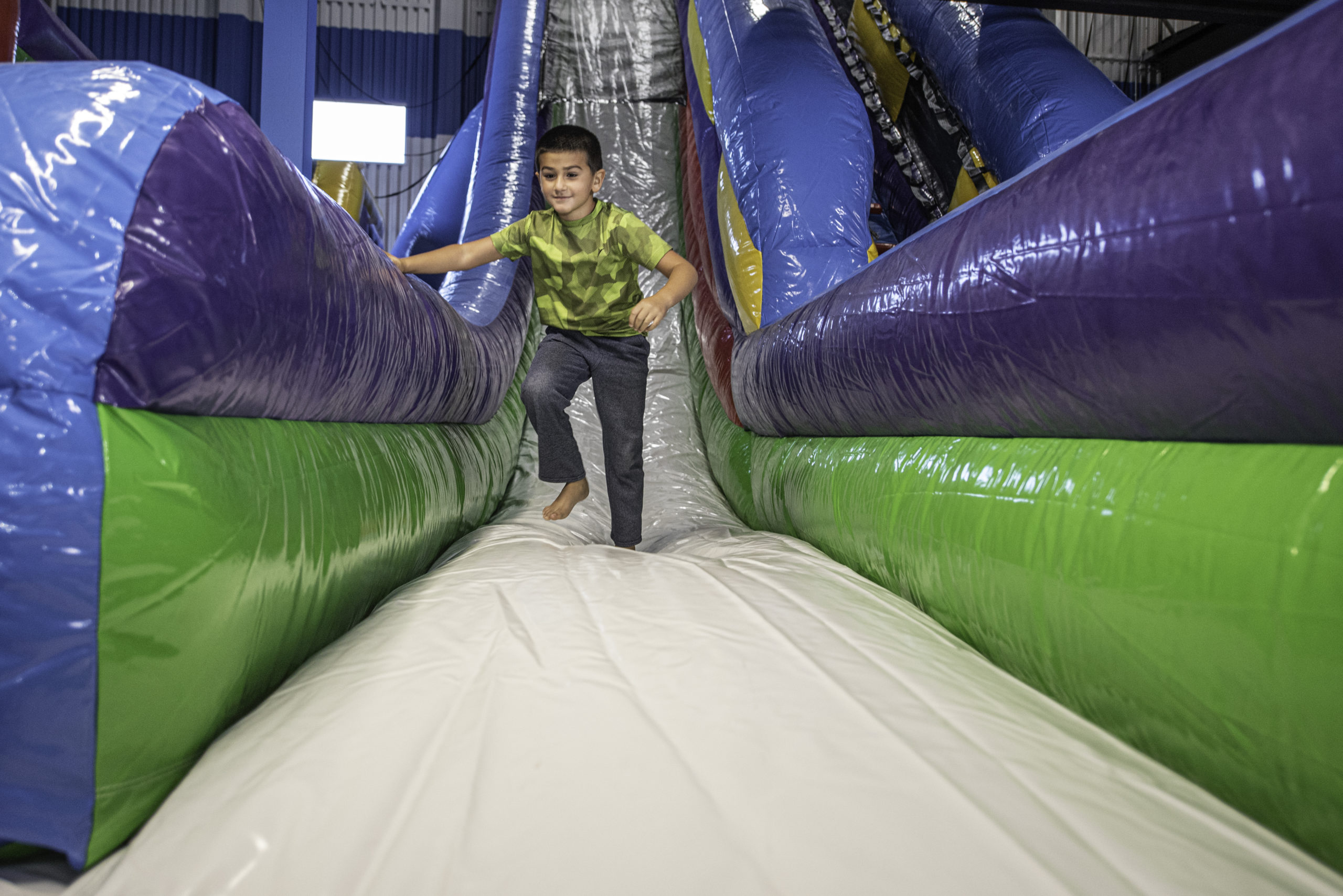Child using the inflatable bounce area at Longplex
