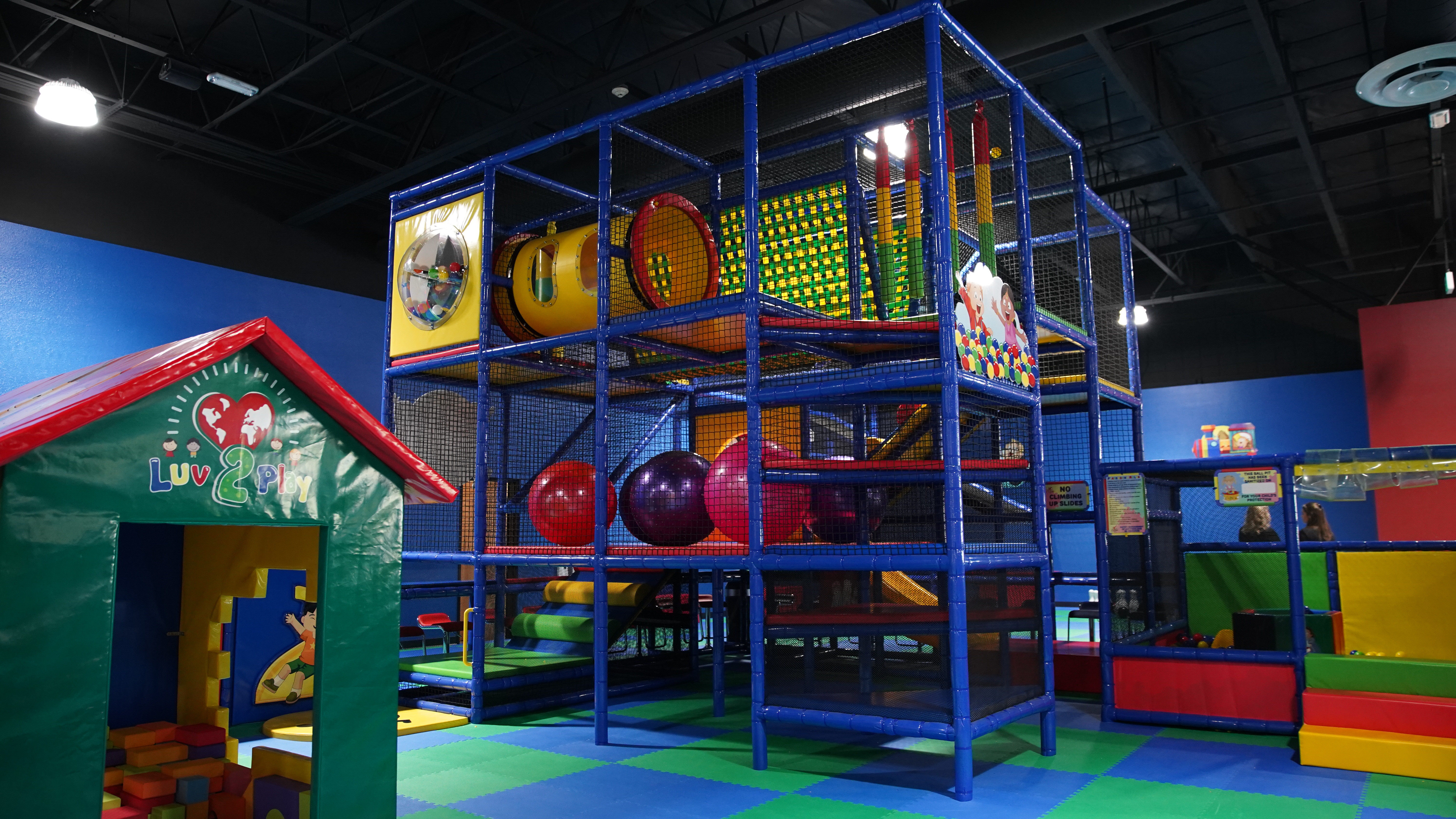 Open play floor with colorful equipment at Luv 2 Play Riverside.