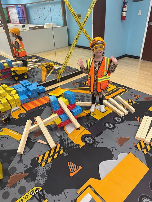 Construction-themed pretend-play area at Magic Meadows Play Place