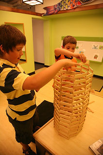 Young child interacting with an exhibit at Maine Discovery Museum.