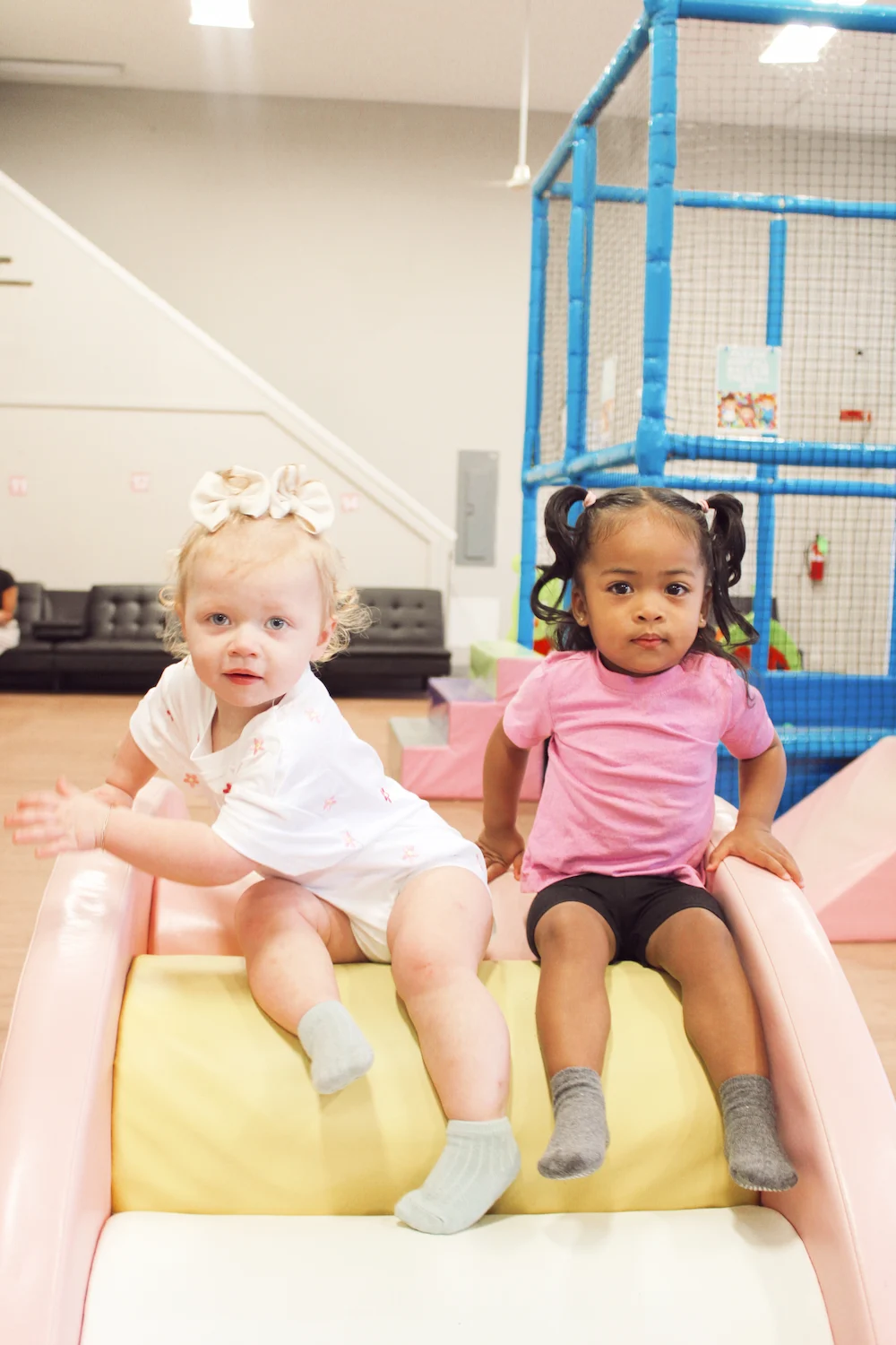 Children sliding in the indoor play area at Mochas & Minis