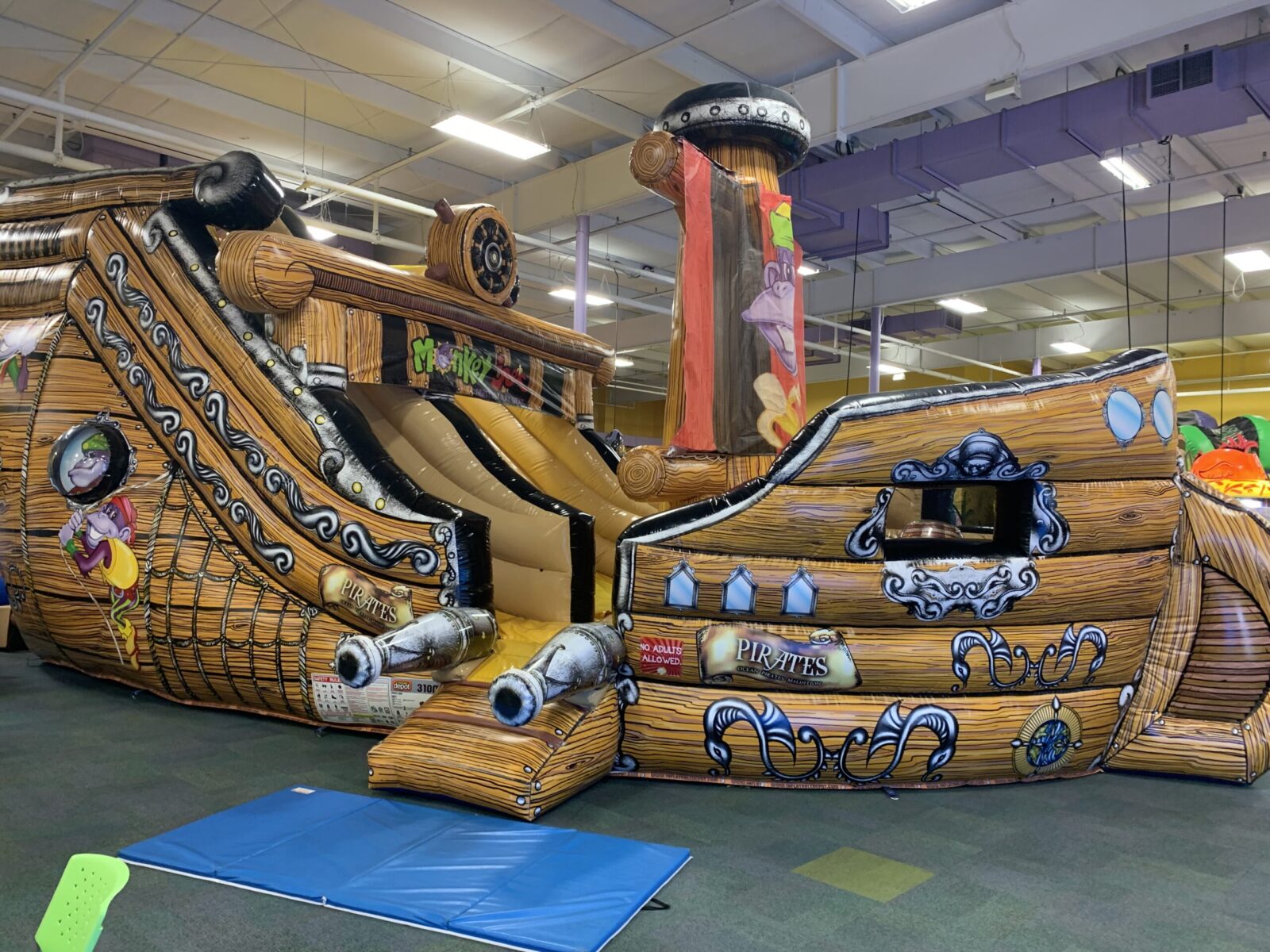 Large inflatable pirate-themed play structure at Monkey Joe's