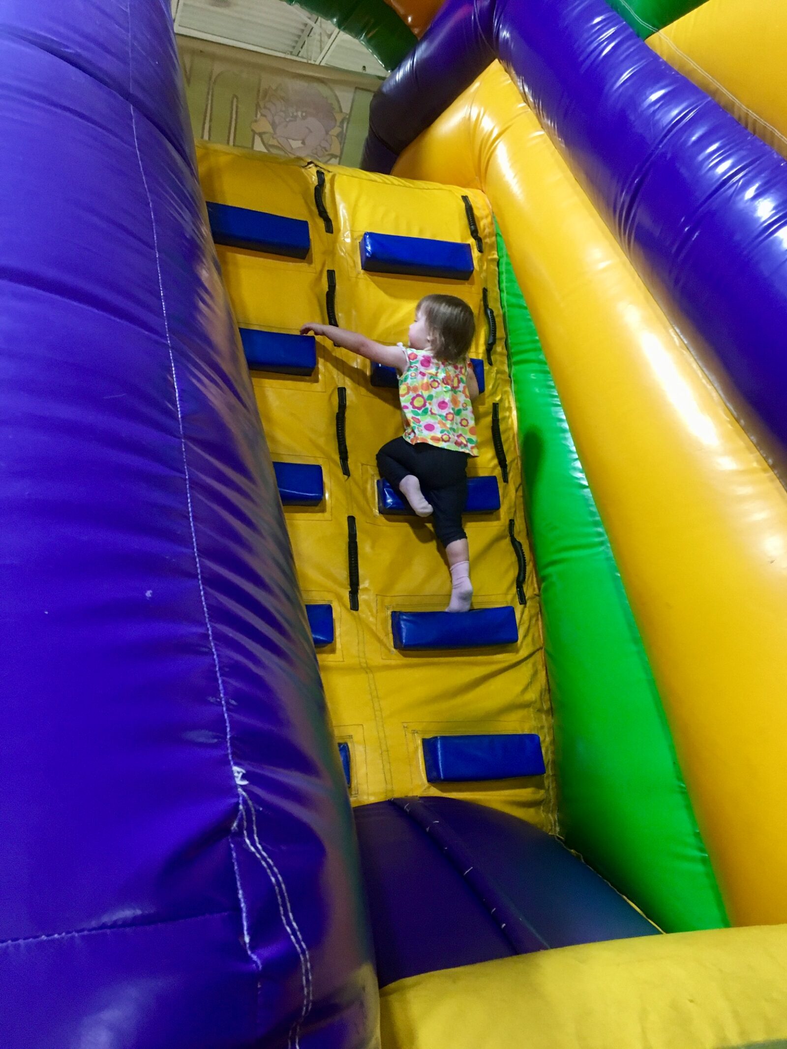 Children climbing and bouncing on inflatable attractions at Monkey Joe's.