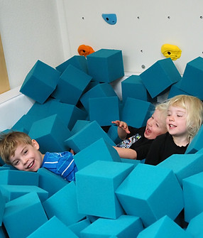 Children playing in the foam-pit area at Mountain Sprouts Play Cafe.