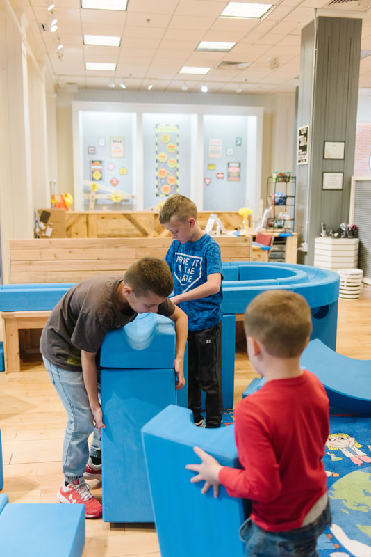 Children using large blue building blocks at My World Discovery Museum