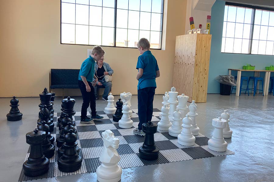 Children playing giant chess at My World Discovery Museum