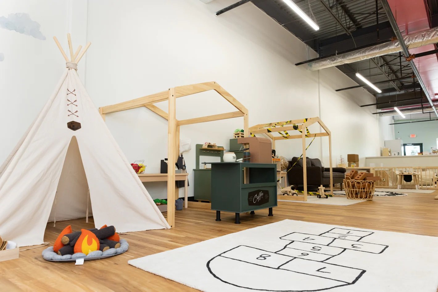 Pretend-play area with teepee and open floor space at Natural Nest Play Cafe Middletown.