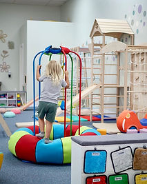 Main play area at Nest and Bloom with toddler-scale play features and open floor space.