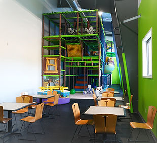 Tables and seating beside the indoor play structure at NLCC.
