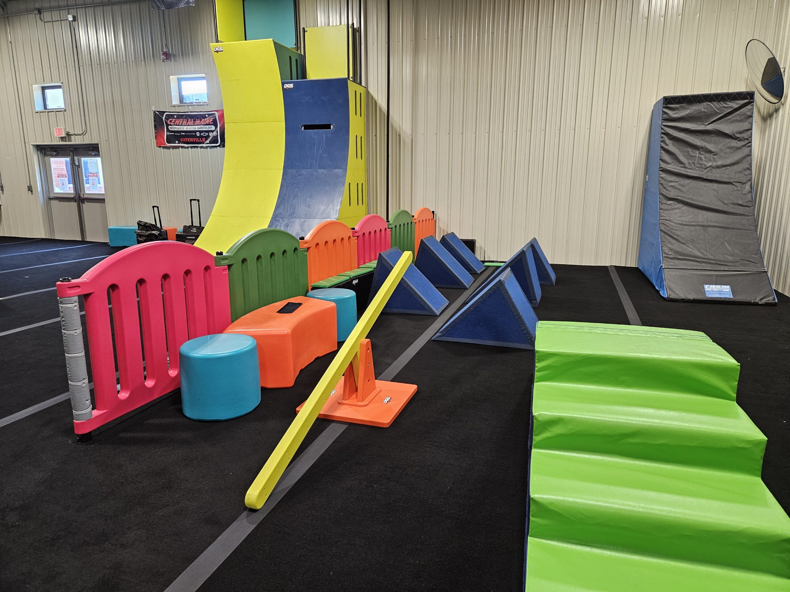 Low obstacle elements and warped-wall style feature for younger visitors.