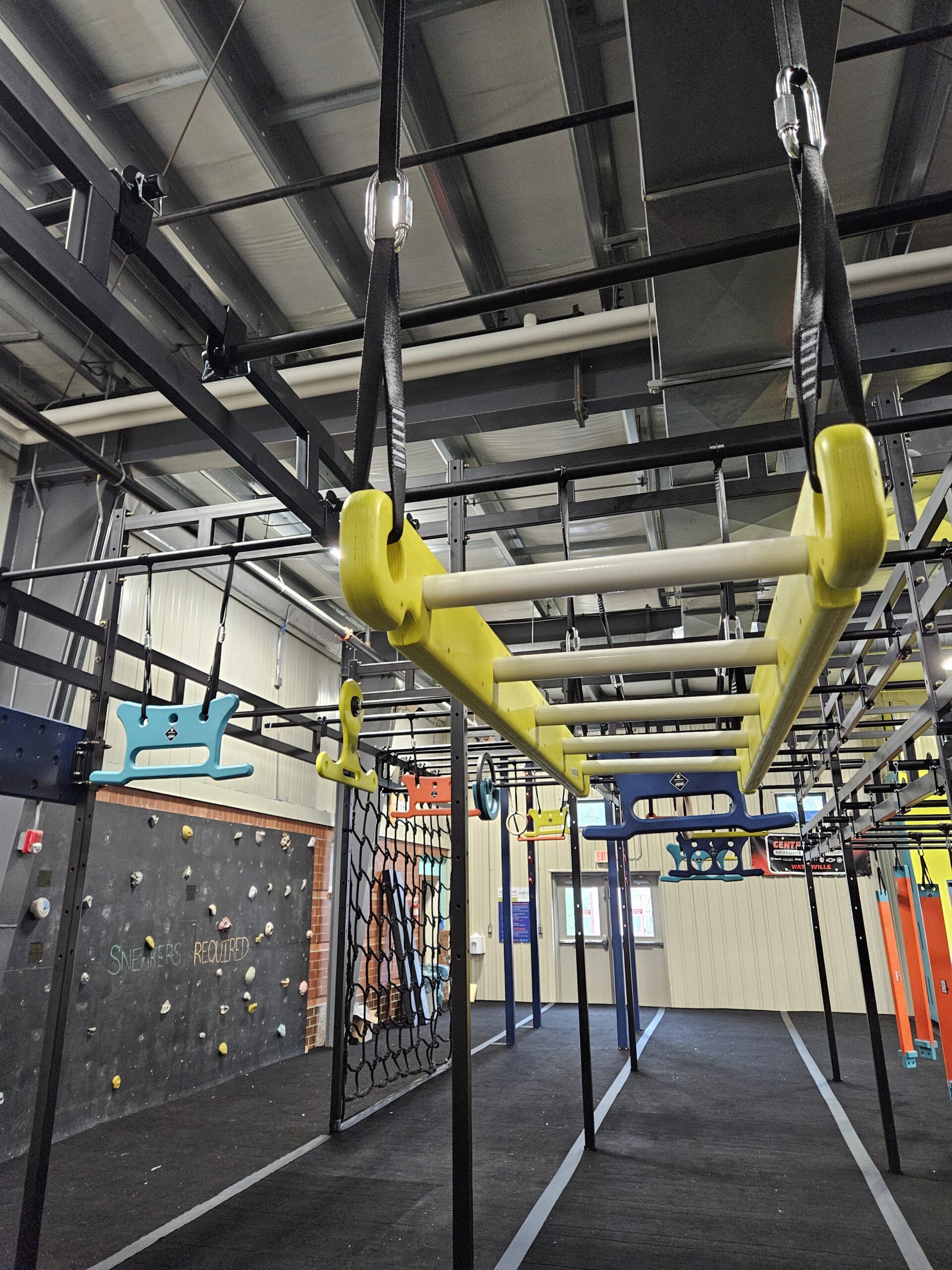 Monkey bars and climbing wall inside NinjAdventure Zone.