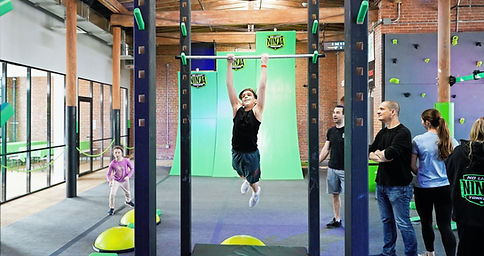 Kids using obstacle-course elements at No Limit Ninja Yonkers