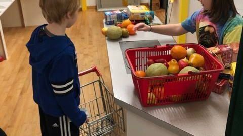 Children using the grocery store exhibit at Northwoods Children's Museum