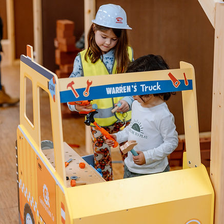 Children using a pretend-play work truck station at Nurture To Play.