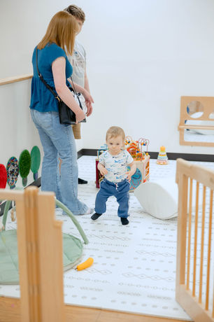 A toddler area with small toys and soft flooring at Nurture To Play.