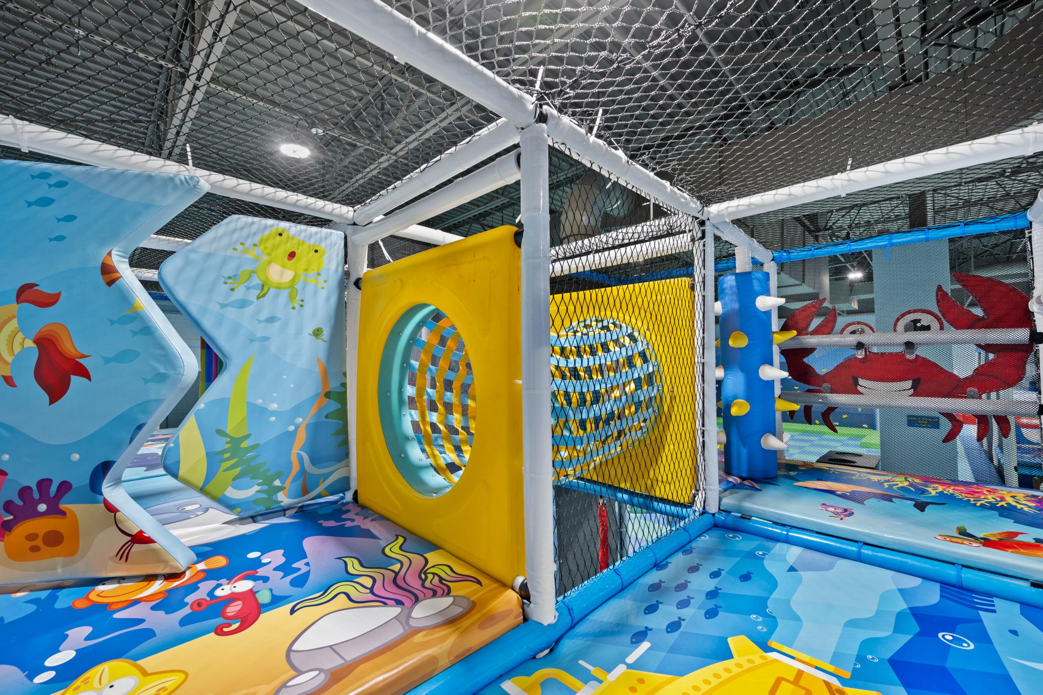 Indoor soft play area with slides and padded equipment