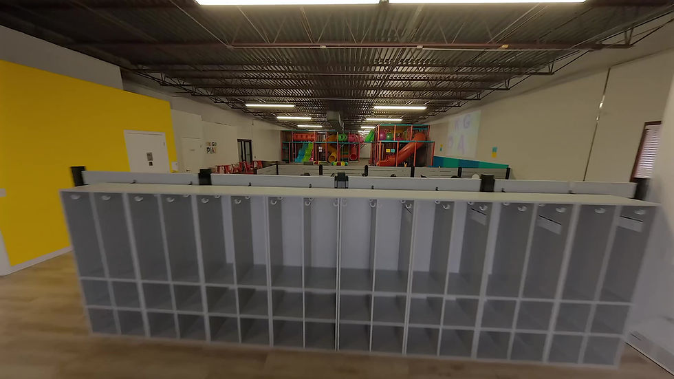 Interior view across the Ok Go Play facility showing cubbies and play areas.