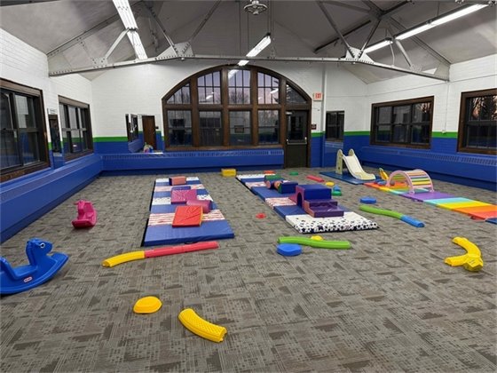 Soft mats and simple play equipment in Owatonna's Indoor Play Space.