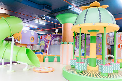 PeekabooO 21st Street play area with pastel structures and a tube slide.