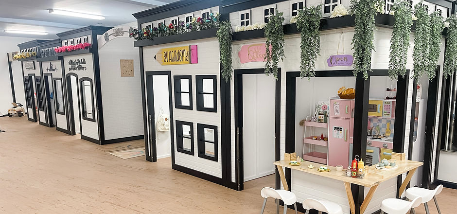 Immersive pretend-play village at Play À La Mode