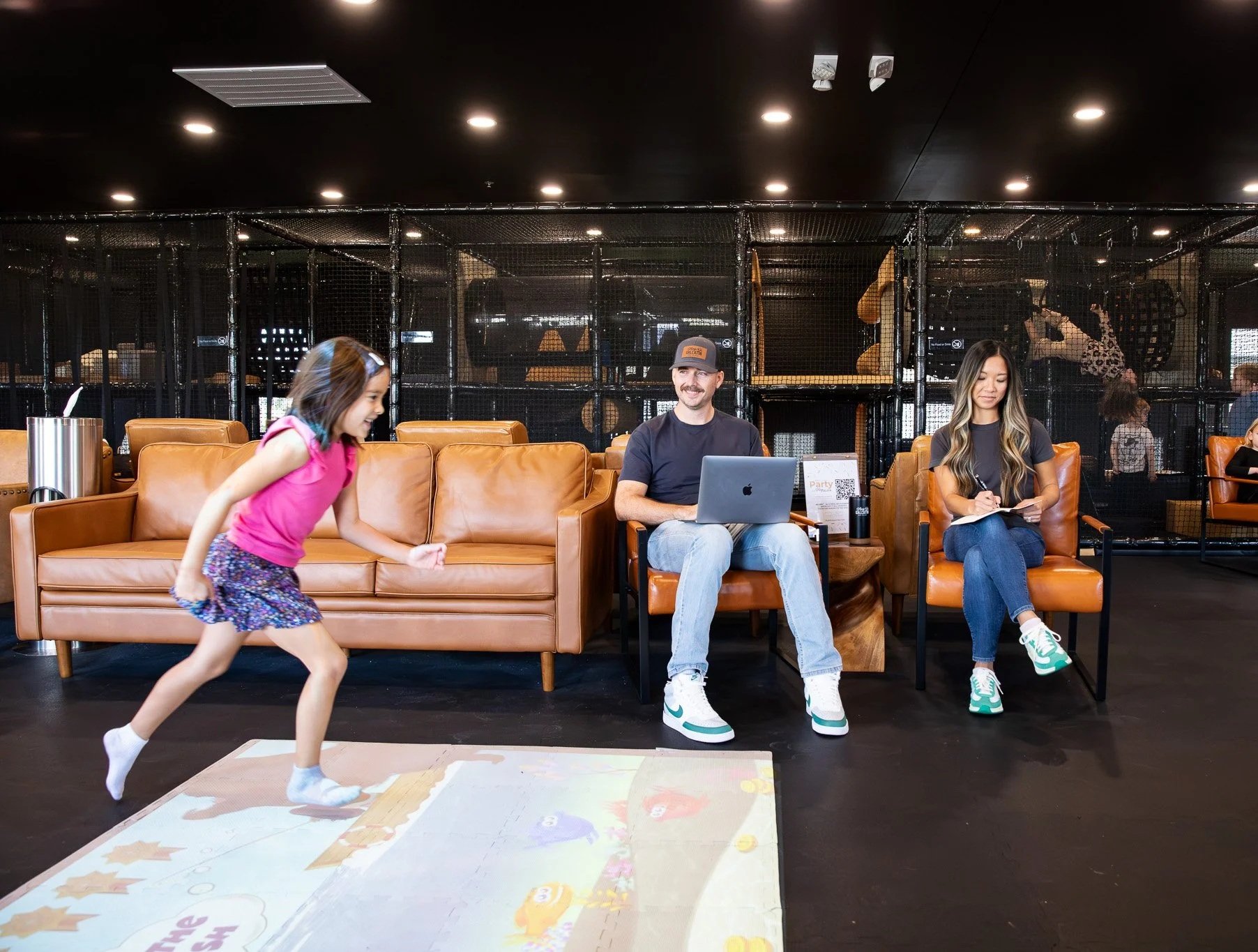 Parents working while a child plays at Play Gallatin