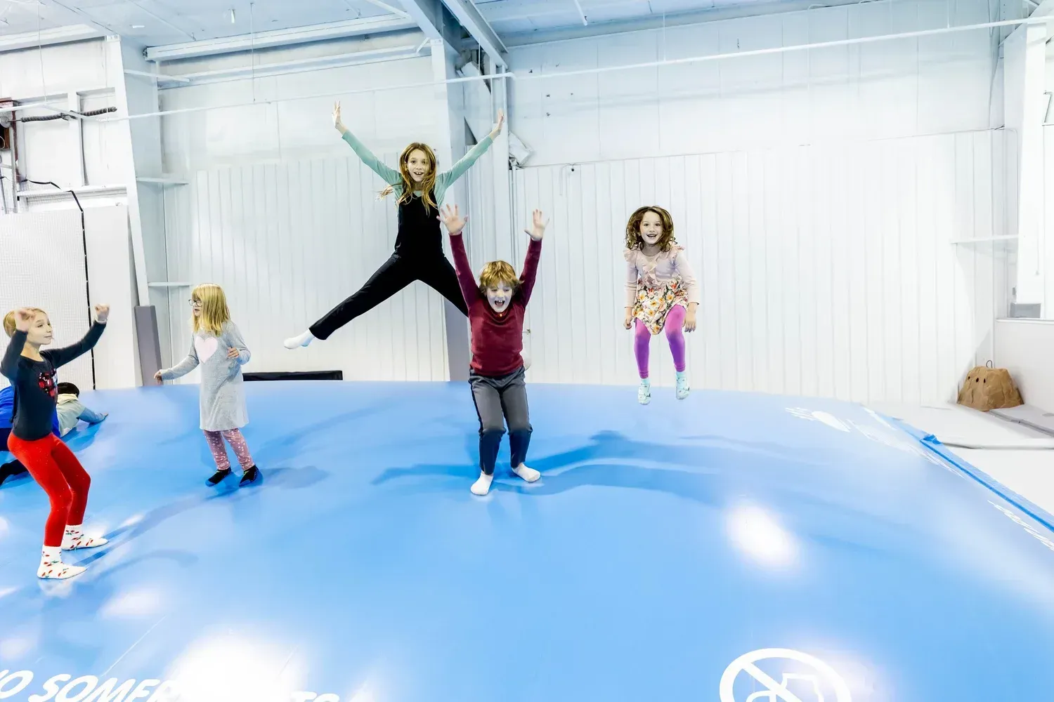 Children jumping on the large indoor jumping pillow at Play Grounds of La Crosse.