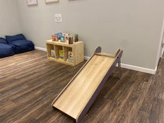 Children exploring imaginative play stations at The Play + Learn at Little Milestones