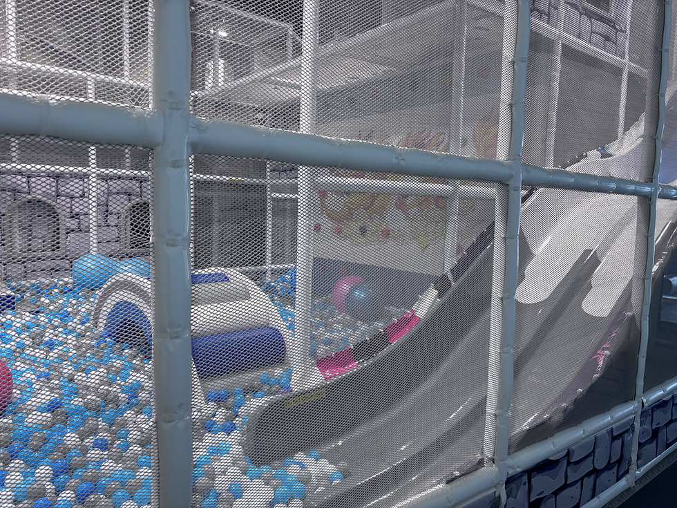 Large slides and a ball pit inside Play Palace in Rochester.