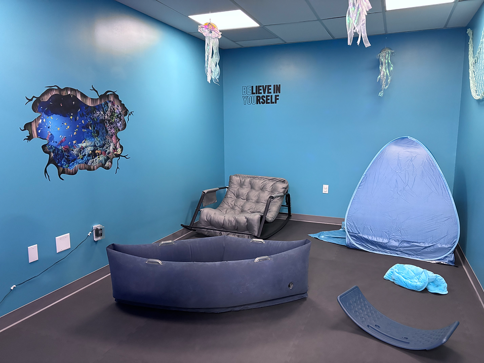 Blue sensory room with calming equipment at Play Palace.