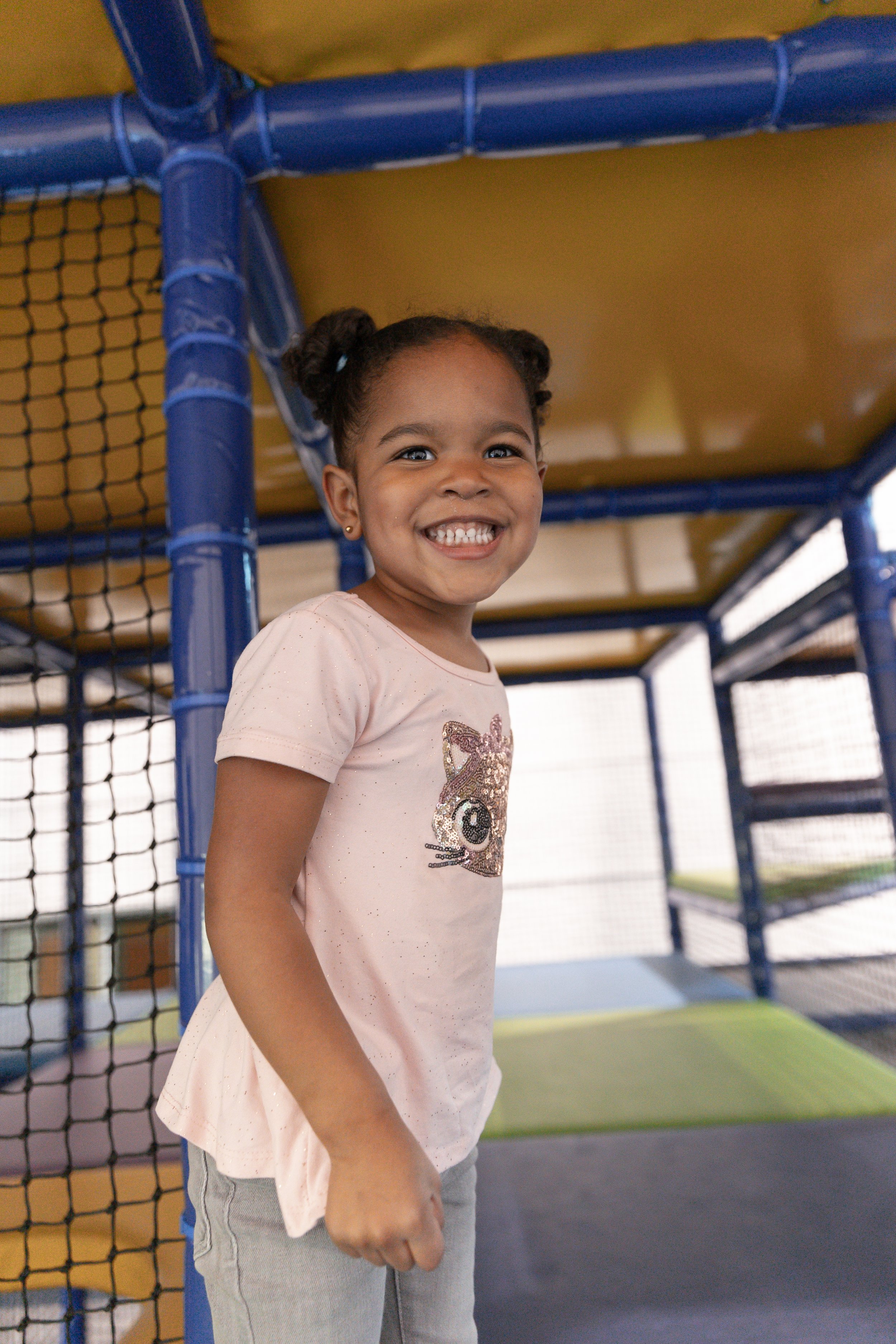 Child climbing in the indoor play structure at Play Park in Novi.
