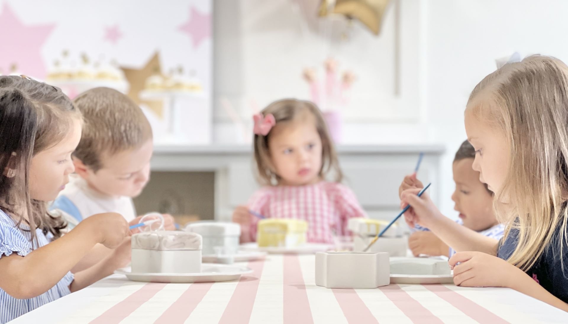 Children seated around a craft table during an activity