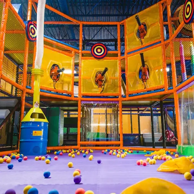 Large colorful indoor play structure at Playdate LLC.