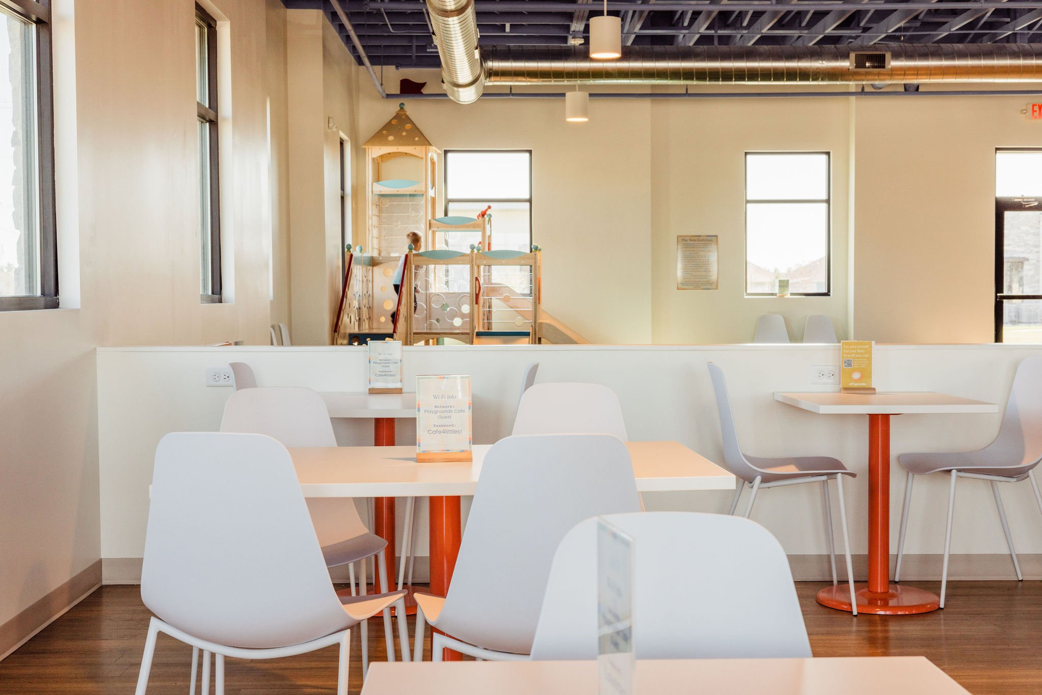 Cafe seating overlooking the play area at PLAYgrounds Cafe