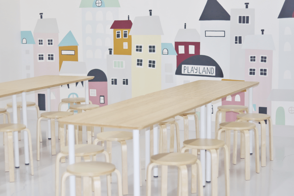 Cafe seating and mural area inside Playland Monroe