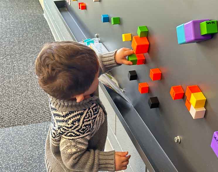 Sensory-style play wall and activity area at Playspace at WL.