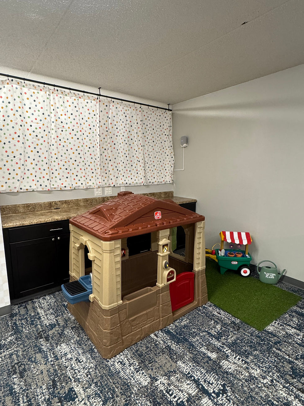 Pretend-play cottage area at Playtime in the Plains.