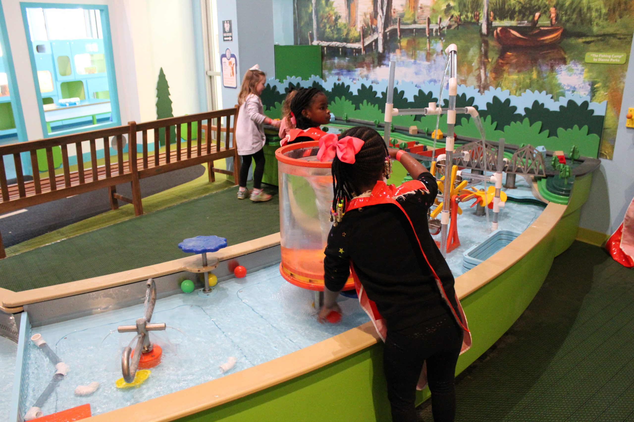 Children using the interactive water table at PoP Children’s Museum.