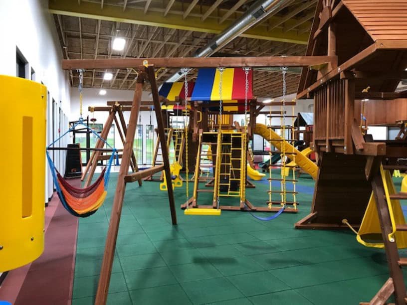 Indoor swing set and play system showroom at Rainbow of the Heartland Des Moines.