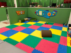 Crawler corner with soft flooring and low play elements at Rainforest Play Zone.