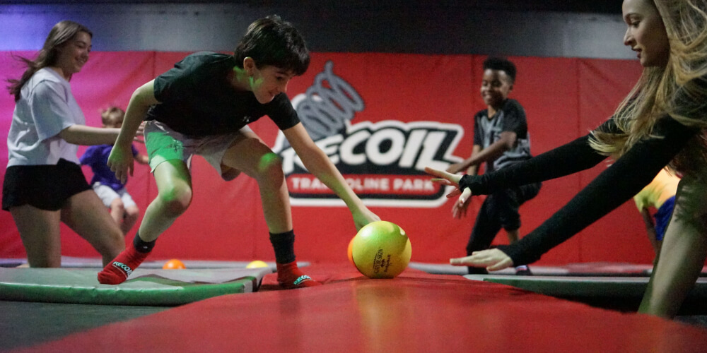 Indoor dodgeball zone at Recoil Trampoline Park.