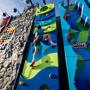 Rock climbing wall attraction at Recoil Trampoline Park.
