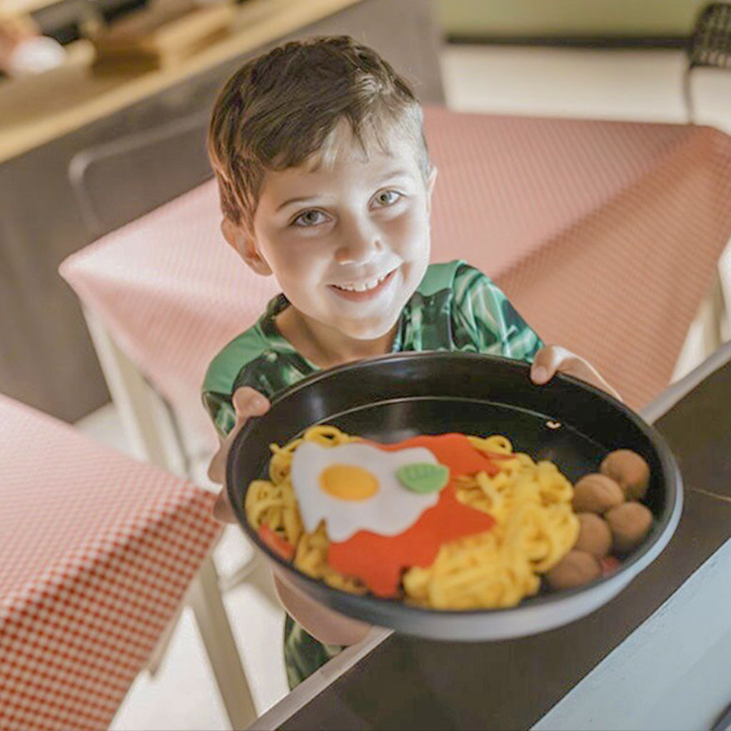 Children using indoor role-play stations at Rise Play Park.