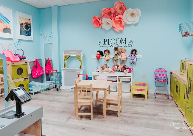 Pretend-play kitchen and market area at Room to Bloom.