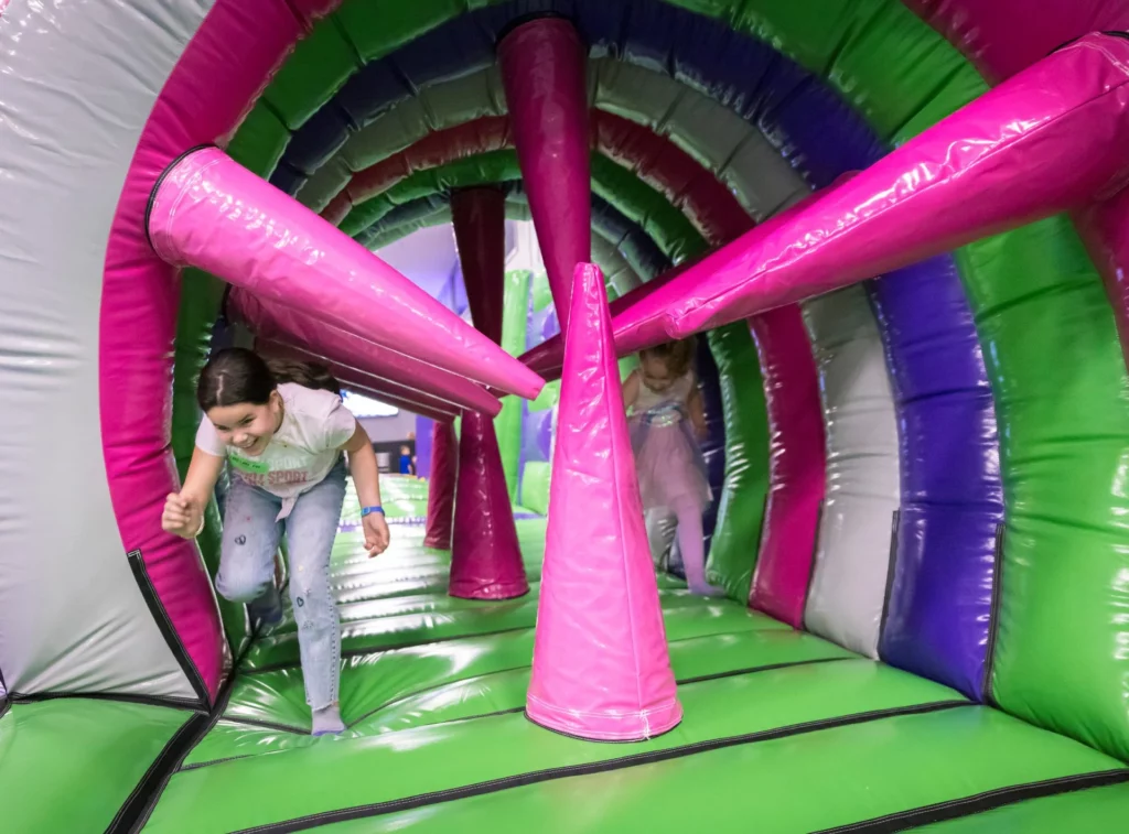 Children navigating inflatable obstacles at Ryan's North Conway airpark.
