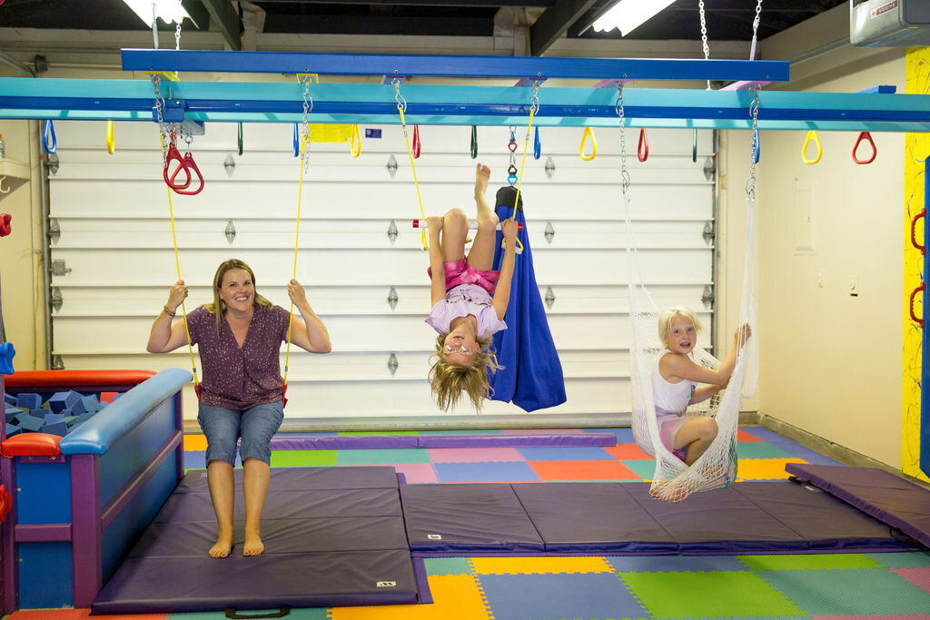 Main sensory gym floor with play equipment at Rylee's Play Place.
