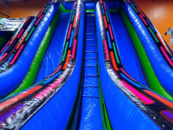 Tall inflatable slide attraction inside Safari Adventure in Riverhead.