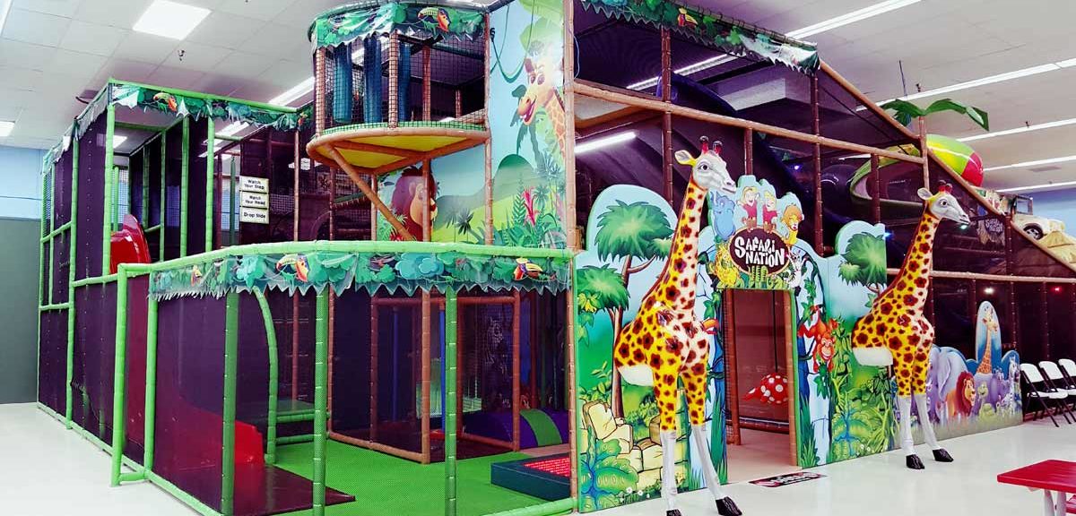 Multi-level jungle gym and themed entrance at Safari Nation Winston-Salem.