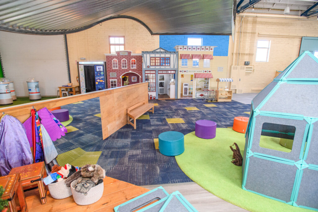 Pretend-play village and indoor exhibit space at Santa Fe Children's Museum